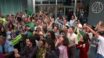 Movie still from “Anchorman: The Legend of Ron Burgundy” (2004), directed by Adam McKay – A large group of people standing in front of a building; Wide shot, High angle