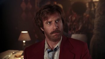 Movie still from “Anchorman: The Legend of Ron Burgundy” (2004), directed by Adam McKay – A person wearing a suit and tie; Close Up shot, Low angle