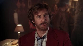 Movie still from “Anchorman: The Legend of Ron Burgundy” (2004), directed by Adam McKay – A person wearing a suit and tie; Close Up shot, Over the shoulder angle