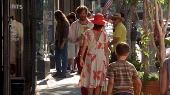 Movie still from “Anchorman: The Legend of Ron Burgundy” (2004), directed by Adam McKay – A group of people walking down a sidewalk; Wide shot, Over the shoulder angle