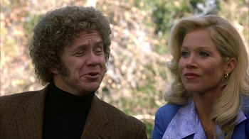 Movie still from “Anchorman: The Legend of Ron Burgundy” (2004), directed by Adam McKay – A man and a woman standing next to each other; Close Up shot, Over the shoulder angle