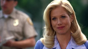 Movie still from “Anchorman: The Legend of Ron Burgundy” (2004), directed by Adam McKay – A woman with blonde hair and blue eyes smiling; Close Up shot, Over the shoulder angle