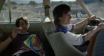 Movie still from “And Your Mother Too” (2001), directed by Alfonso Cuarón – Two people in the back seat of a car; Medium shot, Over the shoulder angle