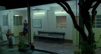 Movie still from “And Your Mother Too” (2001), directed by Alfonso Cuarón – A man standing in front of a window in a room; Extreme Wide shot, Over the shoulder angle