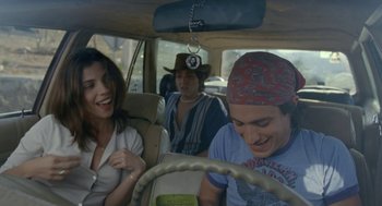 Movie still from “And Your Mother Too” (2001), directed by Alfonso Cuarón – A group of people in the back seat of a car; Medium shot, Over the shoulder angle