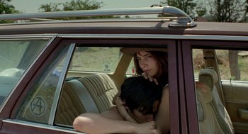 Movie still from “And Your Mother Too” (2001), directed by Alfonso Cuarón – A man and a woman sitting in the back seat of a car; Close Up shot, Over the shoulder angle