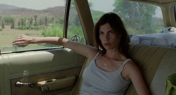 Movie still from “And Your Mother Too” (2001), directed by Alfonso Cuarón – A woman sitting in the driver's seat of a car; Medium shot, Over the shoulder angle