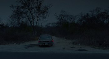 Movie still from “And Your Mother Too” (2001), directed by Alfonso Cuarón – A car parked on the side of a road at night; Extreme Wide shot, High angle