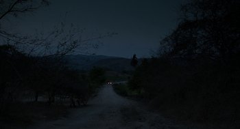 Movie still from “And Your Mother Too” (2001), directed by Alfonso Cuarón – A car driving down a dirt road at night; Extreme Wide shot, High angle
