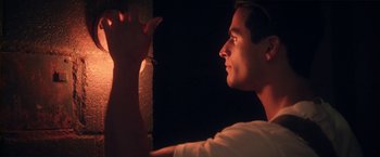 Movie still from “Angel of Anywhere” (2018), directed by James Kicklighter – A person holding something up; Close Up shot, Low angle