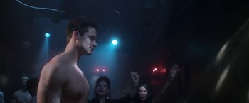 Movie still from “Angel of Anywhere” (2018), directed by James Kicklighter – A group of people in a room with lights on; Medium shot, Low angle