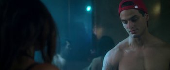 Movie still from “Angel of Anywhere” (2018), directed by James Kicklighter – A man in a red hat is in a mirror; Close Up shot, Over the shoulder angle