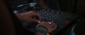 Movie still from “Angel of Anywhere” (2018), directed by James Kicklighter – A person is working on a sound board; Extreme Close Up shot, High angle