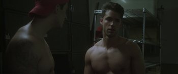 Movie still from “Angel of Anywhere” (2018), directed by James Kicklighter – A man looking at himself in the mirror; Medium shot, Over the shoulder angle