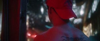 Movie still from “Angel of Anywhere” (2018), directed by James Kicklighter – A person with a red hat is looking at the street lights; Close Up shot, Low angle