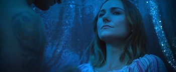 Movie still from “Angel of Anywhere” (2018), directed by James Kicklighter – A woman in a white dress looking up at the sky; Close Up shot, Low angle