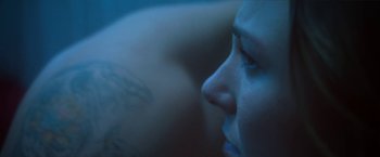 Movie still from “Angel of Anywhere” (2018), directed by James Kicklighter – A woman's face in the dark; Close Up shot, Low angle