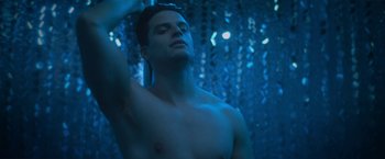 Movie still from “Angel of Anywhere” (2018), directed by James Kicklighter – A man with his shirt off in the dark; Close Up shot, Low angle