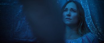 Movie still from “Angel of Anywhere” (2018), directed by James Kicklighter – A woman looking up into the air with her eyes wide open; Close Up shot, Over the shoulder angle