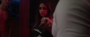 Movie still from “Angel of Anywhere” (2018), directed by James Kicklighter – A woman is holding a straw in front of a mirror; Close Up shot, Over the shoulder angle
