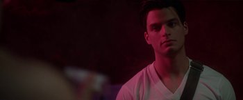 Movie still from “Angel of Anywhere” (2018), directed by James Kicklighter – A man in a white shirt is looking at the camera; Close Up shot, Over the shoulder angle
