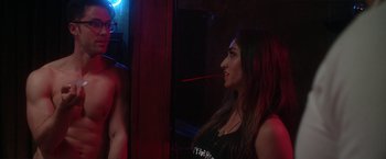 Movie still from “Angel of Anywhere” (2018), directed by James Kicklighter – A woman in a black shirt is looking at herself in the mirror; Medium shot, Over the shoulder angle