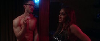 Movie still from “Angel of Anywhere” (2018), directed by James Kicklighter – A man and a woman posing for a picture in a room; Medium shot, Over the shoulder angle