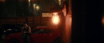 Movie still from “Angel of Anywhere” (2018), directed by James Kicklighter – A red car parked on the side of the road; Medium shot, Low angle