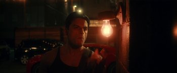 Movie still from “Angel of Anywhere” (2018), directed by James Kicklighter – A man standing in front of a light bulb; Close Up shot, Low angle