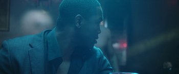 Movie still from “Angel of Anywhere” (2018), directed by James Kicklighter – A person sitting at a table; Close Up shot, Over the shoulder angle