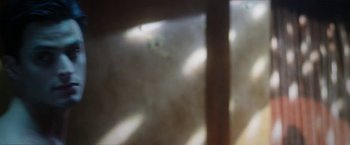 Movie still from “Angel of Anywhere” (2018), directed by James Kicklighter – A blurry image of a cat in a window; Extreme Close Up shot, Low angle