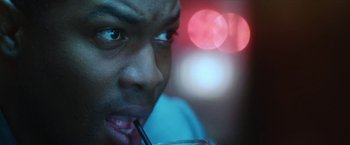 Movie still from “Angel of Anywhere” (2018), directed by James Kicklighter – A person holding a glass of water; Extreme Close Up shot, Over the shoulder angle