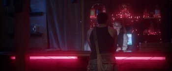 Movie still from “Angel of Anywhere” (2018), directed by James Kicklighter – A man standing in front of a mirror in front of a woman; Medium shot, Over the shoulder angle