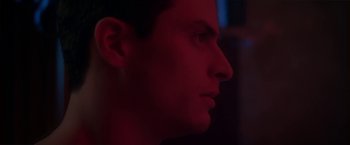 Movie still from “Angel of Anywhere” (2018), directed by James Kicklighter – A man's face in the dark; Close Up shot, Low angle
