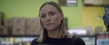 Movie still from “Angel of Anywhere” (2018), directed by James Kicklighter – A person wearing a black and white sweater; Close Up shot, Over the shoulder angle