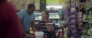 Movie still from “Angel of Anywhere” (2018), directed by James Kicklighter – A man and a woman shopping in a grocery store; Medium shot, Over the shoulder angle