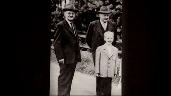 Movie still from “Angst” (1983), directed by Gerald Kargl – A black and white photo of two men and a boy; Medium shot, High angle