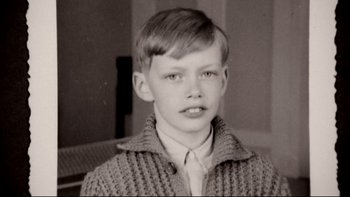 Movie still from “Angst” (1983), directed by Gerald Kargl – An old photo of a young boy wearing a sweater and a tie; Close Up shot, Overhead angle