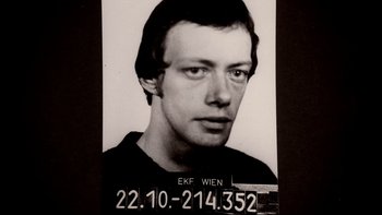 Movie still from “Angst” (1983), directed by Gerald Kargl – A black and white photo of a man's mugshot; Close Up shot, Overhead angle