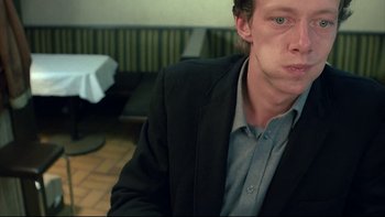 Movie still from “Angst” (1983), directed by Gerald Kargl – A person wearing a jacket; Close Up shot, High angle