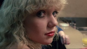 Movie still from “Angst” (1983), directed by Gerald Kargl – A person with blonde curly hair; Close Up shot, Low angle