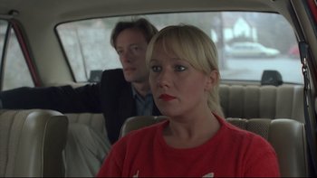 Movie still from “Angst” (1983), directed by Gerald Kargl – A man and a woman sitting in the back of a car; Close Up shot, Low angle
