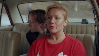 Movie still from “Angst” (1983), directed by Gerald Kargl – A woman sitting next to a man in a car; Close Up shot, Over the shoulder angle