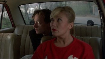 Movie still from “Angst” (1983), directed by Gerald Kargl – A man and a woman sitting in the back of a car; Close Up shot, Over the shoulder angle