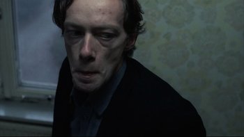 Movie still from “Angst” (1983), directed by Gerald Kargl – A person wearing a jacket; Close Up shot, Low angle