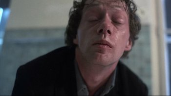Movie still from “Angst” (1983), directed by Gerald Kargl – A person with his eyes closed; Close Up shot, Low angle