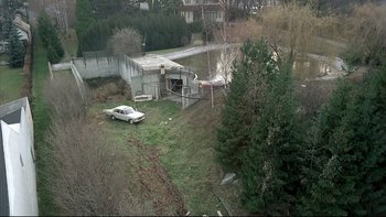 Movie still from “Angst” (1983), directed by Gerald Kargl – An aerial view of an old car parked in front of a pond; Extreme Wide shot, High angle