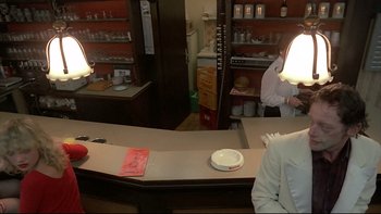 Movie still from “Angst” (1983), directed by Gerald Kargl – A man sitting at a counter in a restaurant; Medium shot, Over the shoulder angle