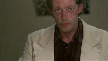 Movie still from “Angst” (1983), directed by Gerald Kargl – A person wearing a jacket; Close Up shot, Low angle