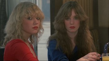 Movie still from “Angst” (1983), directed by Gerald Kargl – Two young women sitting next to each other; Close Up shot, Low angle